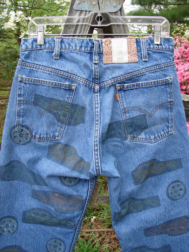 1995 Levi Strauss & Co Denim Blue Jean Travel Dark Stone Wash Size 1, featuring travel-themed paint, front and rear pockets with orange tag, and a specialized blue fish patch on the waistline.