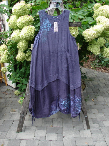 Barclay NWT Linen Explorer Jumper Botanical Blossom Purple River Mist Size 0: A sleeveless, ankle-length dress with patch pockets and tiered hem, hanging outdoors, showcasing soft crinkled fabric and floral accents.