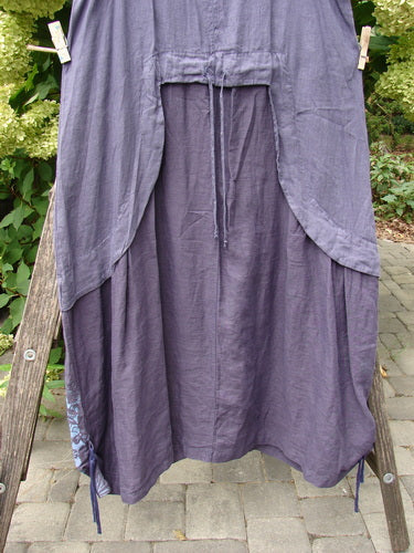 Barclay NWT Linen Explorer Jumper Botanical Blossom Purple River Mist Size 0, displayed on a garden ladder, features a scoop neckline, drawstring waist, side panels, and decorative hem ties.