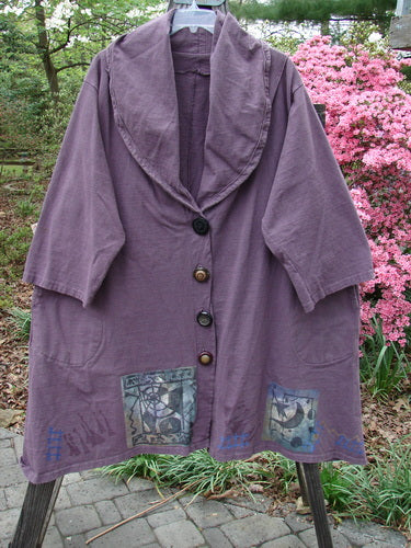 1994 Reprocessed Carriage Jacket Star Moon Fuji Purple Altered OSFA displayed on a rack, featuring oversized buttons, deep side pockets, and a billowy collar, showcasing a patchwork design and celestial theme.