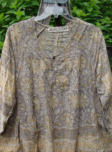 Magnolia Pearl European Cotton Block Print Briar Tunic Top Flower Child OSFA features a flowing A-line shape with raw edges, dual inseam pockets, and Henley snap buttons, showcasing artistic vintage-inspired design.
