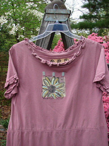 1991 Milkmaid Dress Daisy Dusty Pink OSFA displayed on a hanger, featuring a flower design, drop waistband, curly hem, and sleeve line, accented with a center lower hip bell shape.