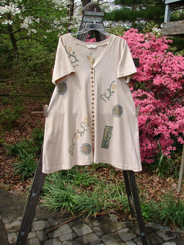 1995 Tiny Button Dress Fruit Floral Garden Flax Size 1 displayed on a rack, featuring intricate button details and a feminine hourglass shape with a V neckline and swingy hem.