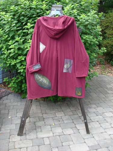 1998 Patched Autumn Coat Fall Leaf Madder OSFA displayed on a stand, featuring oversized ceramic buttons, a cozy hood, foldable cuffs, and brightly painted fall-themed patches.