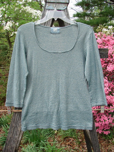 2000 Litmus Squareneck Top Unpainted Puddle Size 1 showcased on a hanger, highlighting its wide neckline, neat accents, and slightly flared hips, perfect for layering.