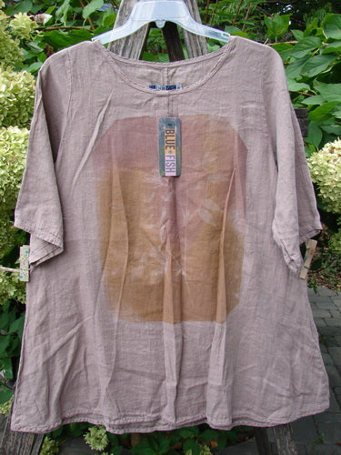 Barclay NWT Linen Lucida Top Moon Fern Oriel Size 0, featuring a flowy A-line shape with a rounded neckline and color-block panel, hanging outdoors against leafy shrubs.