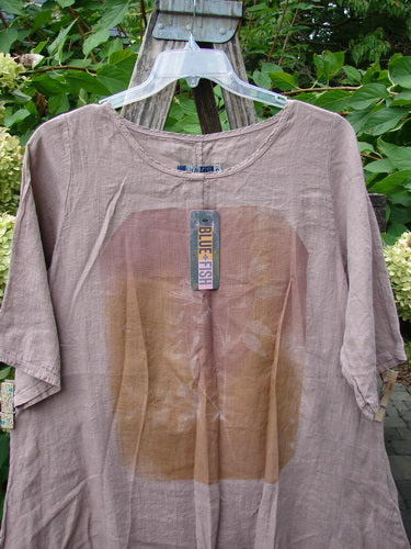 Barclay NWT Linen Lucida Top Moon Fern Oriel Size 0, featuring a flowy A-line shape and rounded neckline, with a circular graphic on the front, hanging on a clear hanger.