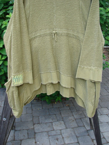 Barclay Patched Crepe Perennial Tunic Top in Woods Olive Size 2 displayed on a rack, showcasing textured cotton crepe fabric, front pockets, empire waist seam, and rounded neckline.