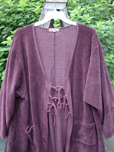 Barclay Chenille Rippie Tie Front Robe Jacket Unpainted Murple Size 2 displayed on a hanger, showcasing its double drop front pockets, deep V neckline, and smooth vertical cotton paneling.