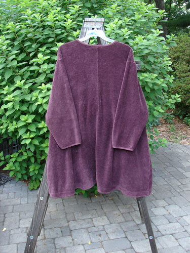 Barclay Chenille Rippie Tie Front Robe Jacket Unpainted Murple Size 2 displayed on a hanger outdoors, showcasing its double drop front exterior pockets and varying hemline.