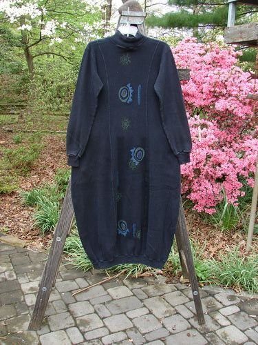 1996 Thermal Day Dress Abstract Black Size 0 displayed on a wooden stand, featuring an hourglass shape, ribbed cuffs and hemline, mock rib T-neck, and unique painted abstract design.