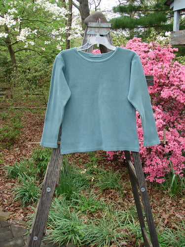 1997 Thermal Long Sleeved Top Unpainted Cypress Size 1 displayed on a wooden rack, showcasing its thick cotton thermal fabric, continuous neckline stitchery, and slightly tapered waistline.