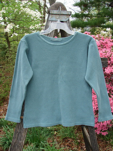 1997 Thermal Long Sleeved Top Unpainted Cypress Size 1 displayed on a hanger, showcasing its thick cotton thermal fabric, continuous neckline stitchery, and slightly tapered waistline, perfect for layering.