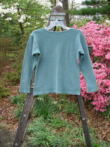 1997 Thermal Long Sleeved Top Unpainted Cypress Size 1 displayed on a wooden ladder, showcasing its thick cotton thermal fabric ideal for layering, with detailed neckline stitchery and a slightly tapered waistline.