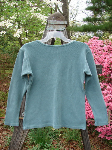 1997 Thermal Long Sleeved Top Unpainted Cypress Size 1 displayed on a swinger, showcasing its thick cotton thermal fabric, continuous neckline stitchery, and slightly tapered waistline.