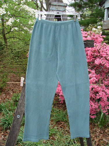 1997 Thermal Bootleg Pant Unpainted Cypress Size 1 hanging on a clothesline, showcasing its slightly flared boot cut and full elastic waist.