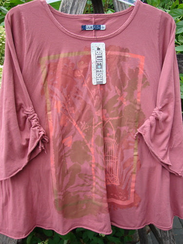 Barclay NWT Draw Gather Sleeve Cafe Top Free Bird Desert Size 0, showcasing a loose-fit design with ruched sleeves and abstract front panel, draped over a wooden rack, highlighting BlueFishFinder's unique vintage style.