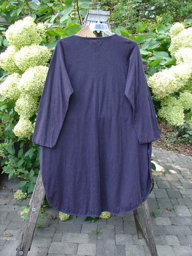 Barclay NWT Natalia Tunic Dried Floral Metallics Plum River Size 1 hangs on a wooden ladder outdoors. This tunic features a rounded neckline, lettuce-edged sleeves, and high side vents.