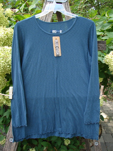 Barclay NWT Modal Slub Long Sleeved Simple Tee Unpainted Morocco Size 0 displayed on a weathered wooden ladder, featuring long narrow sleeves, A-line shape, raw edges, and a rounded neckline.