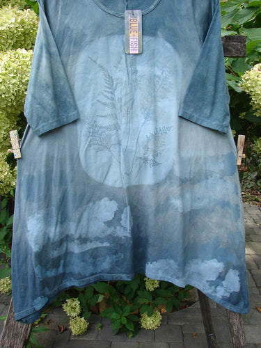 Barclay NWT Wander Tunic Tee Moon Fern, Mottled Grey Green Size 0, features a large moon design with fern fronds on a loose-fitting tunic hanging on a wooden ladder, embodying Bluefishfinder.com's vintage essence.