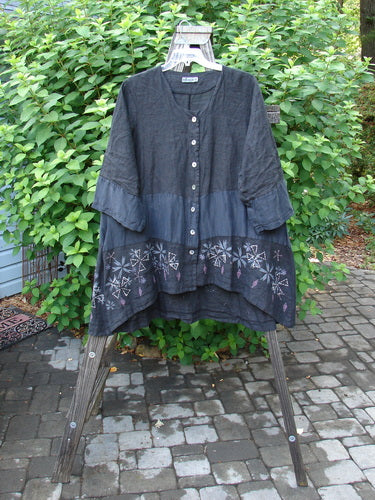 Barclay Linen Wonderland Sectional Banded Cardigan Lucky 4 Black Size 2 displayed on a hanger, featuring a scooped neckline, belled sleeves, and thick pearly buttons with whimsical paint details.