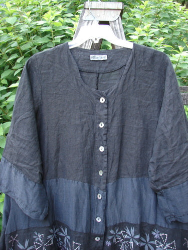 Barclay Linen Wonderland Sectional Banded Cardigan Lucky 4 Black Size 2 displayed on a hanger, showcasing its scooped neckline, belled sleeves, thick pearly buttons, and unique horizontal alternating panels.