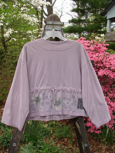 2000 Wide Crop Jacket Dance Flower Hyacinth Size 0 displayed on a swing, showcasing its A-line flair, front variegated buttons, and dance flower border theme against an outdoor background.