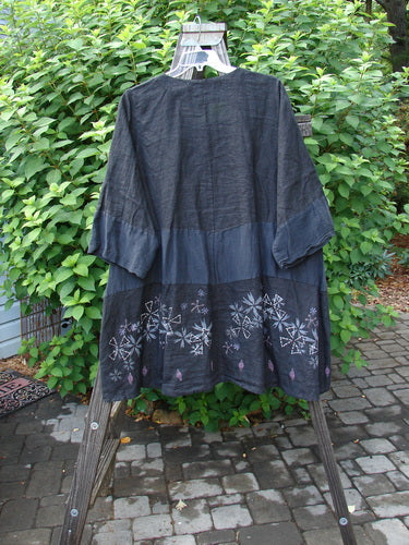 Barclay Linen Wonderland Sectional Banded Cardigan Lucky 4 Black Size 2 displayed on a mannequin, featuring a scooped neckline, belled sleeves, thick pearly buttons, and whimsical horizontal alternating panels.