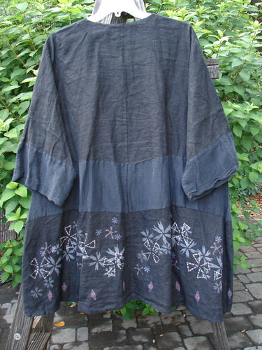 Barclay Linen Wonderland Sectional Banded Cardigan Lucky 4 Black Size 2, featuring a scooped neckline, belled sleeves, thick pearly buttons, and whimsical continuous paint design, displayed against a neutral background.