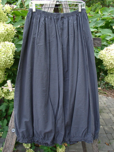Barclay NWT Batiste Airy Lawn Skirt Unpainted Black Sand Size 0, featuring a full elastic waist and hem, displayed outdoors on a hanger, highlighting its billowy, gathered silhouette.