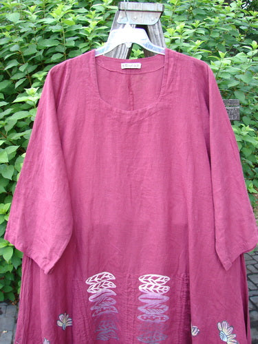Barclay Linen Venetian High Vent Tunic Dress Cornflower Berry Size 2 displayed on a hanger, showcasing its flowing mid-weight linen fabric, wide hemline, and distinctive neckline.
