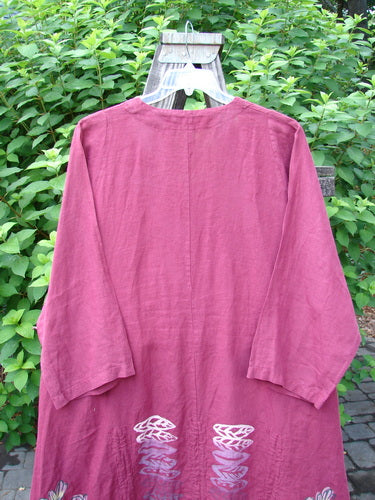 Barclay Linen Venetian High Vent Tunic Dress Cornflower Berry Size 2 displayed on a hanger, highlighting its feminine hourglass shape, wide hemline, and triple drawcords.