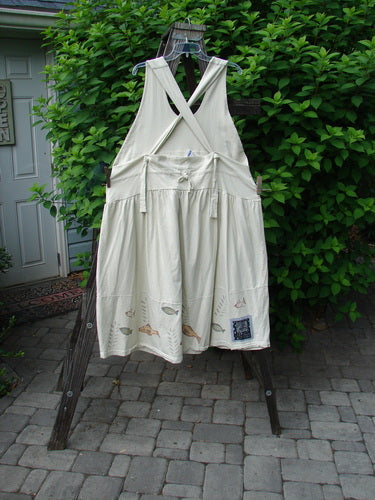 1999 NWT Tadpole Jumper Single Stripe Pike Natural OSFA displayed on a wooden rack, showcasing adjustable shoulder straps, sweeping hemline, drawcord crisscross back, and round-bottomed pockets in perfect condition.