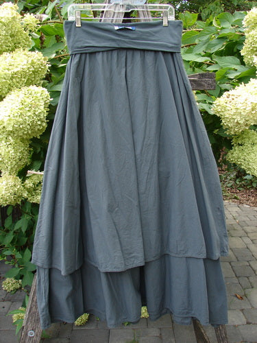 Barclay NWT Batiste Fold Over Stardust Tier Skirt Atlas Grey Size 0, featuring a flowing maxi-length with a wide waistband and two overlapping tiers, displayed outdoors on a hanger.