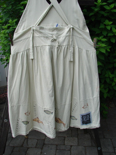 1999 NWT Tadpole Jumper Single Stripe Pike Natural OSFA hanging on a clothesline, showcasing its adjustable shoulder straps, sweeping hemline, and distinctive criss-cross back drawcord.