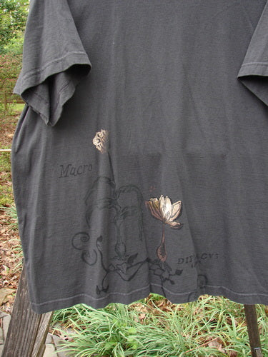 1998 Botanicals Short Sleeved Tee Macro Raven Size 2 features a black t-shirt with a detailed flower design, longer boxy shape, ribbed neckline, and Blue Fish Patch, made from organic cotton.