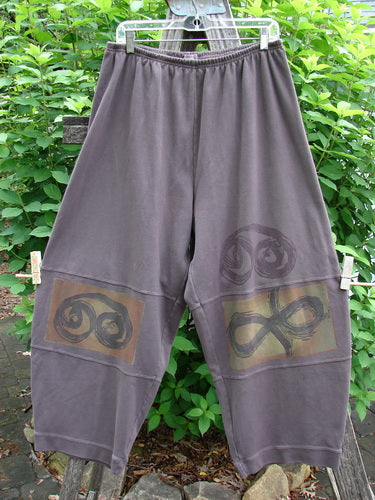 2000 Interlock Moors Pant Celtic Peat Size 2 features a unique pegged shape, elastic waistband, three sectional panels, and Celtic-themed paint, reflecting BlueFishFinder's creative and vintage style.