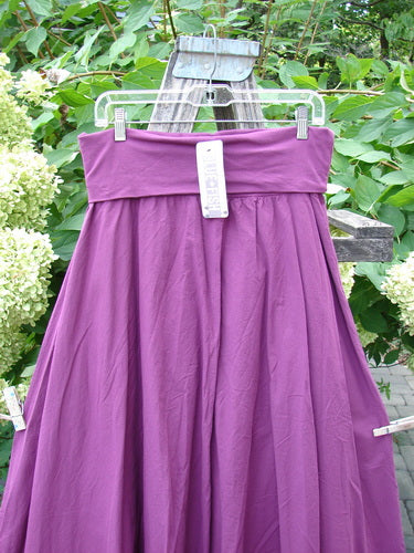 Barclay NWT Batiste Fold Over Stardust Tier Skirt Tyrian Berry Size 0 on hanger outdoors, showcasing its deep-purple, two-tiered, full-length design with a forgiving waistline and generous hips.