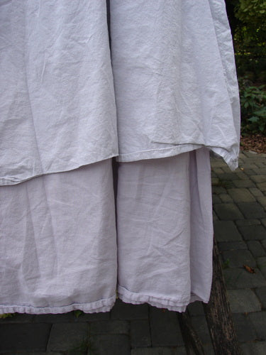 Barclay NWT Batiste Two Story Shaunting Skirt in Pearl Smoke, displayed draped over a wooden rail, showcasing its light, two-tiered design and full elastic waistline, emphasizing Bluefishfinder's vintage aesthetic.