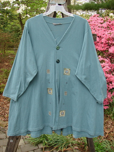 1997 Mask Jacket Quad Celtic Knot Cypress Size 2, featuring a blue bell-shaped swing design, two-button closure, deep side pockets, and a unique drawcord back, in mid-weight cotton.