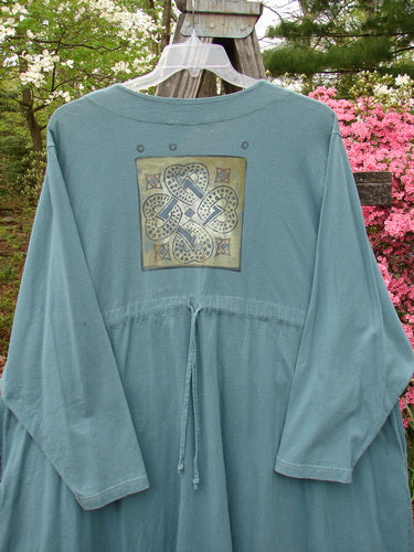 1997 Mask Jacket Quad Celtic Knot Cypress Size 2 - blue shirt with a gold design, bell shape, two special buttons, deep side pockets, varying swing hemline, and a slightly raised drawcord back.