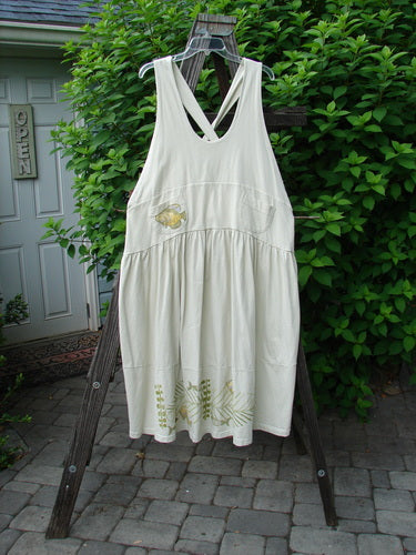 1999 NWT Tadpole Jumper Single Gold Fish Sky Natural OSFA, featuring adjustable shoulder straps, a sweeping hemline, criss-cross back, double-paneled waistline, and pockets, displayed on a wooden rack.