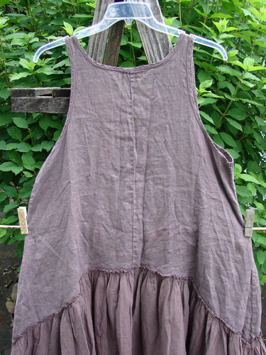 Barclay Linen Batiste Summer Frock Jumper in Floral Grid Rosewood, features a midweight gauze bodice, batiste flounce, oval neckline, deep pockets, and a unique downward yoked skirt, embodying vintage elegance.