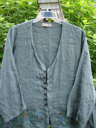 Barclay Linen Tiny Button Dip Side Cardigan Daisy Field Green Mineral Size 0 with deep V-neckline, textured buttons, three-quarter sleeves, and side vents, showcasing a relaxed and artistic silhouette.