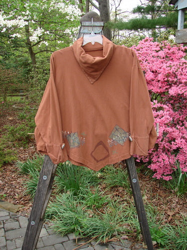1996 Equilateral Top Primitive Cassia OSFA displayed on a wooden stand, showcasing its unique cuffed double-layered pointed sleeves, pointed collar, and dramatic A-line swing hemline.