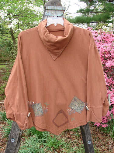 1996 Equilateral Top Primitive Cassia OSFA displayed on a wooden pole, showcasing unique double-layered pointed sleeves with cloth buttons, and a specialized pointed collar and hemline.