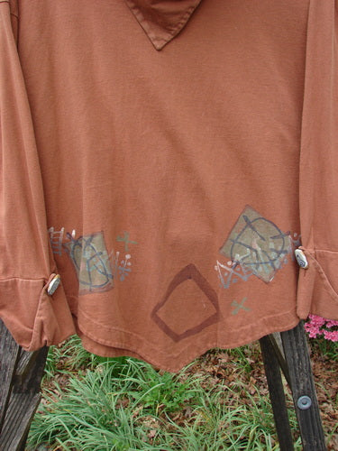 Close-up of the 1996 Equilateral Top Primitive Cassia OSFA, featuring uniquely cuffed double-layered pointed sleeves with cloth-covered buttons and a dramatic A-line swing.