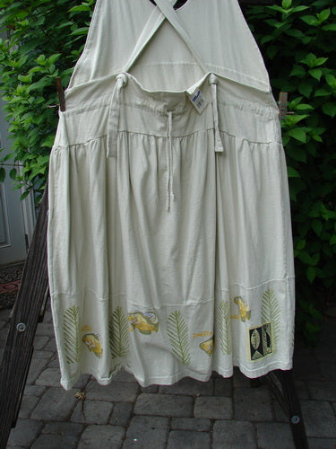 White Tadpole Jumper with gold fish design, adjustable straps, sweeping hemline, and criss-cross lower back, hanging on a clothesline from the 2000 Summer Collection, BlueFishFinder.com.