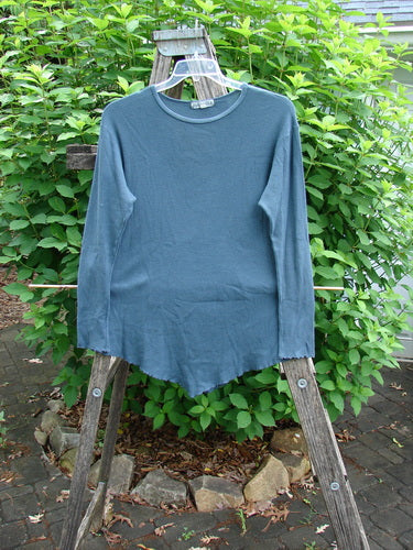 Barclay Thermal Stretch Long Sleeved Curl Edge Top Unpainted Teal Size 1, featuring a rolled neckline, longer sleeves with curly edges, and a unique reverse hemline, ideal for versatile layering.