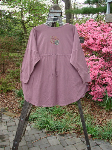1996 Long Sleeved Pop Top Tea Time Laurel OSFA displayed on a swing, featuring a rounded hemline, scooped rolled neckline, and oversized front pocket with textured button.